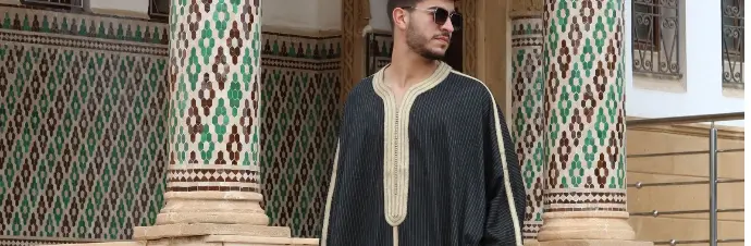 Moroccan artisan crafting a traditional thobe with precision